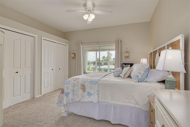 carpeted bedroom featuring two closets and ceiling fan