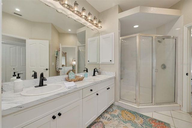 bathroom featuring vanity, tile patterned floors, and walk in shower