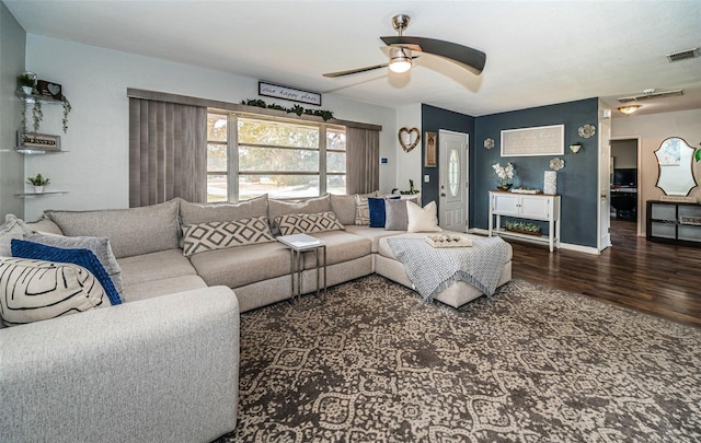 living room featuring dark wood-type flooring and ceiling fan