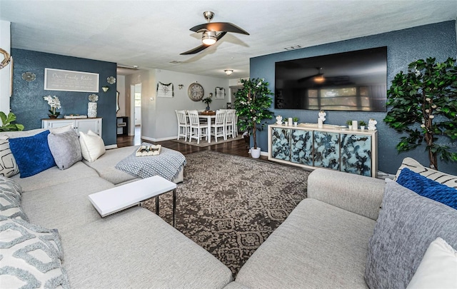 living room with wood-type flooring and ceiling fan