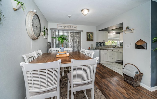 dining space with sink and hardwood / wood-style floors