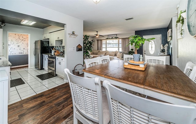 dining room with light wood-type flooring and ceiling fan