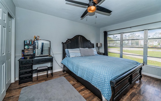 bedroom featuring a closet, dark hardwood / wood-style floors, and ceiling fan