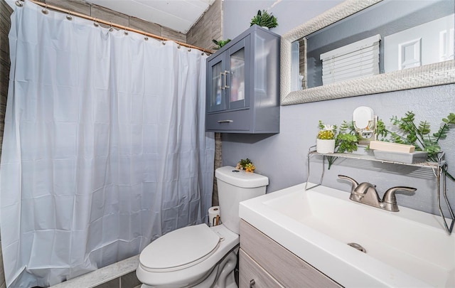 bathroom featuring vanity, curtained shower, and toilet