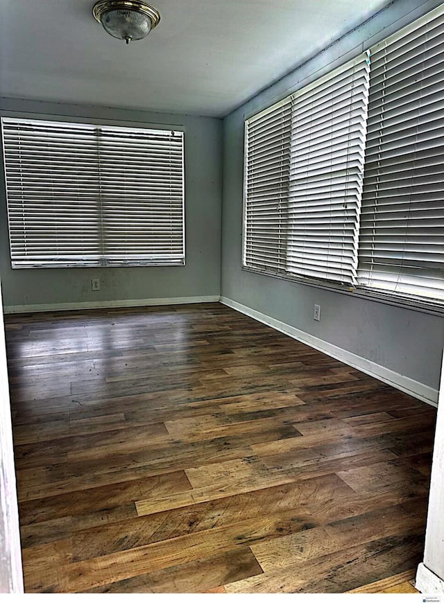 spare room with dark hardwood / wood-style floors