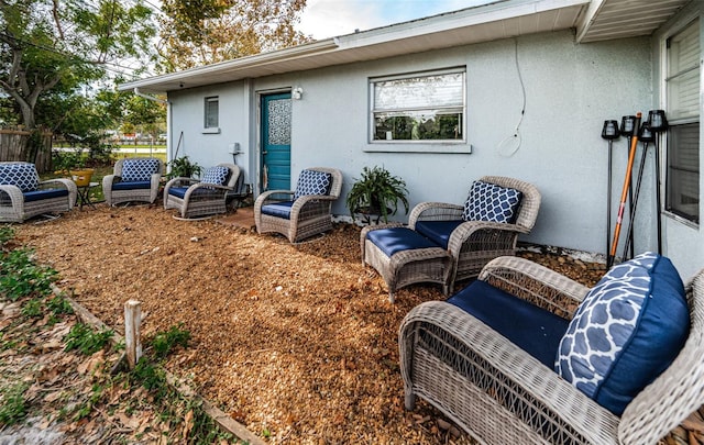 rear view of property with an outdoor hangout area