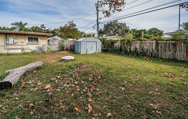 view of yard with central AC and a shed