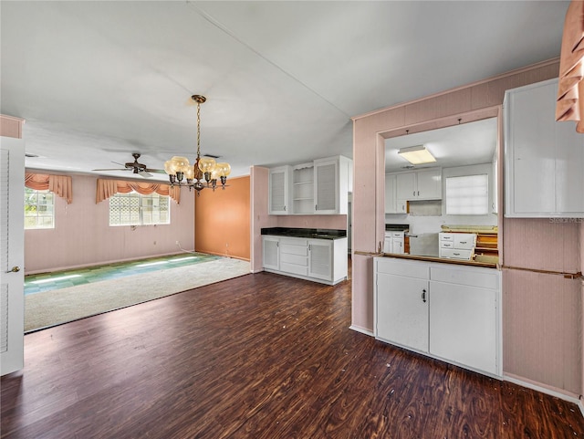 kitchen featuring white cabinets, dark hardwood / wood-style floors, ceiling fan, and hanging light fixtures