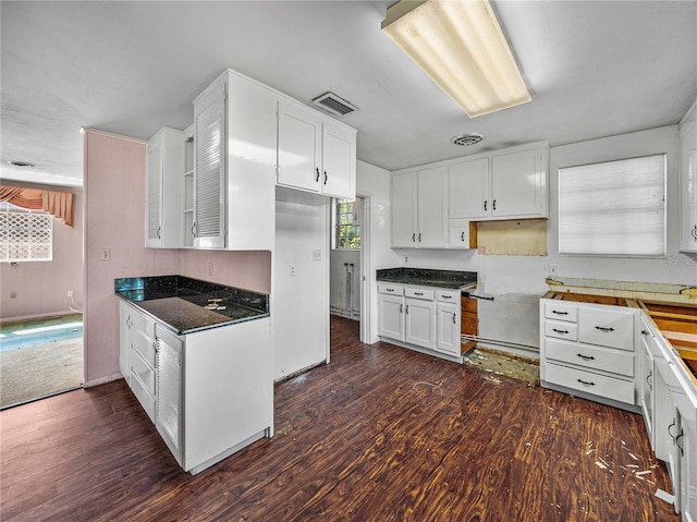 kitchen featuring white cabinets and dark wood-type flooring