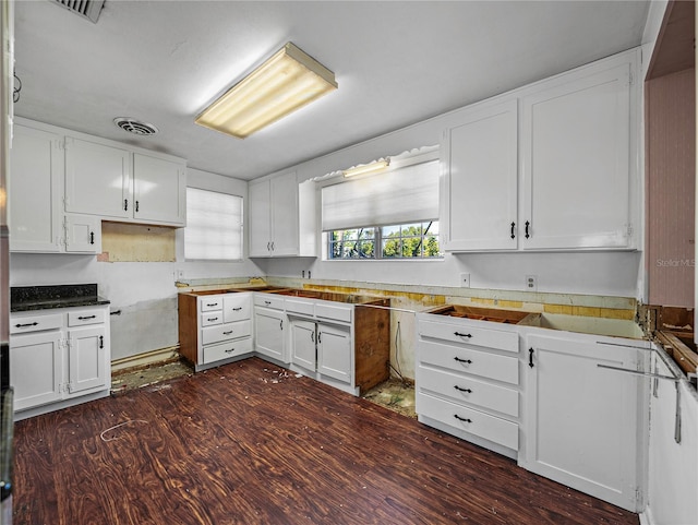 kitchen with white cabinets and dark hardwood / wood-style flooring