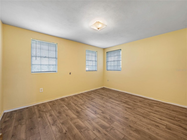 spare room with wood-type flooring