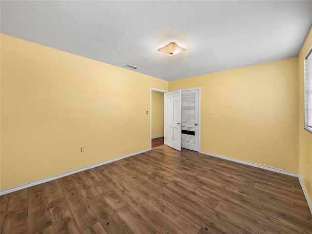 unfurnished bedroom featuring dark wood-type flooring