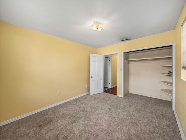 unfurnished bedroom featuring carpet floors and a closet