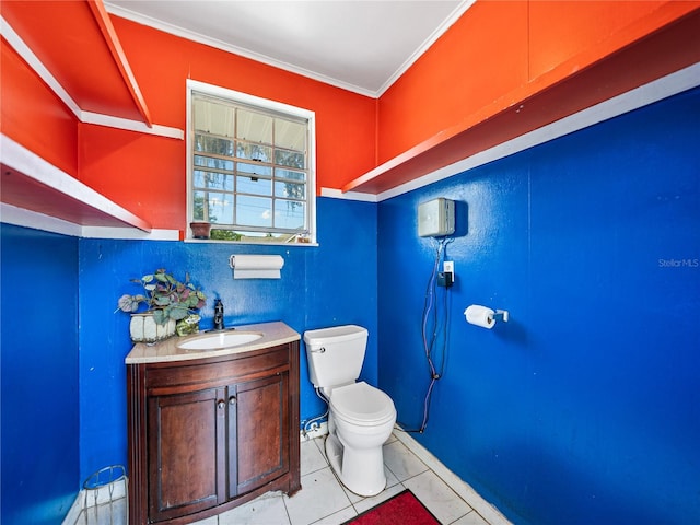 bathroom with tile patterned flooring, vanity, toilet, and ornamental molding