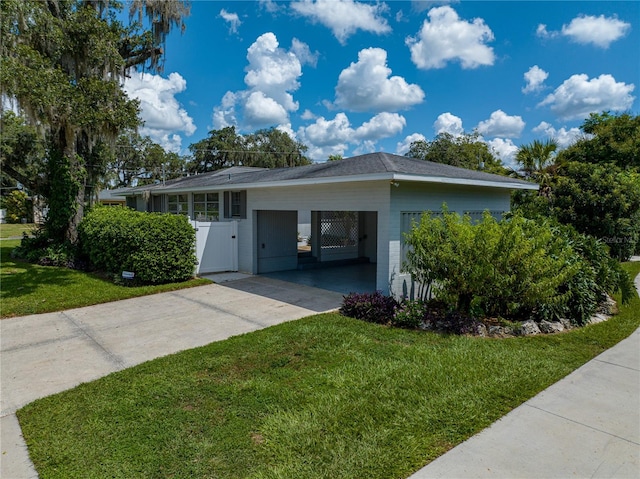 view of property exterior featuring a lawn and a carport