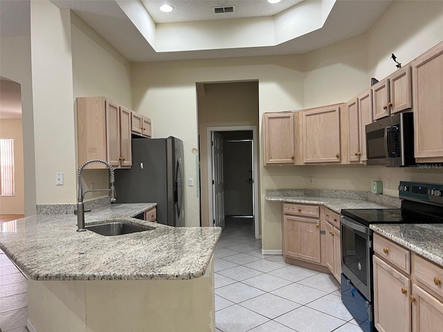 kitchen featuring light brown cabinetry, sink, and appliances with stainless steel finishes