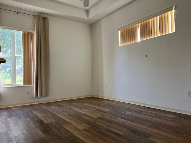 unfurnished room with dark hardwood / wood-style flooring