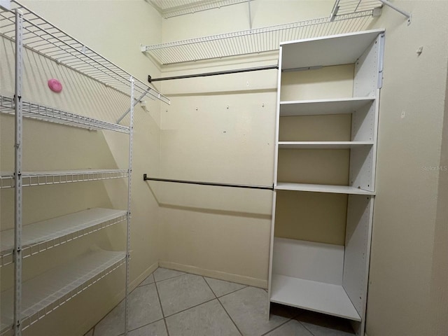 walk in closet with light tile patterned floors