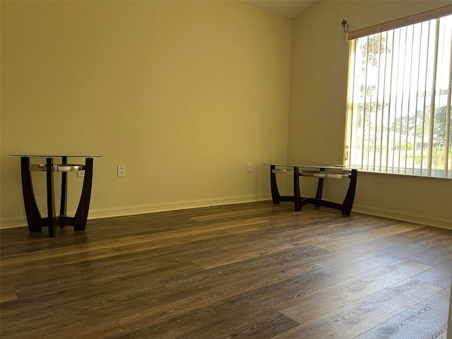 empty room with dark hardwood / wood-style flooring