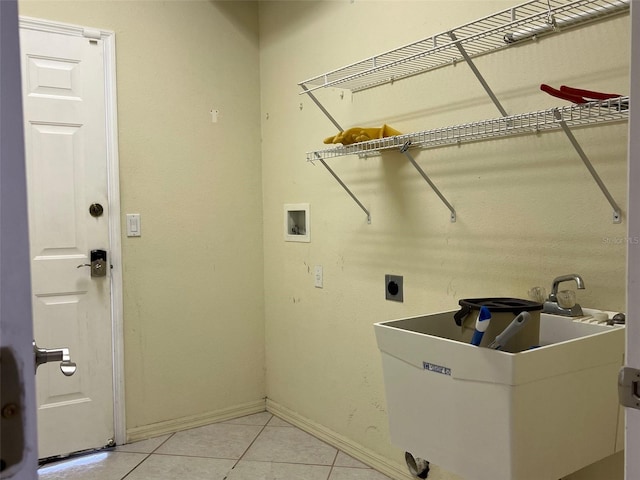 washroom featuring sink, electric dryer hookup, washer hookup, and light tile patterned floors