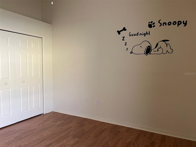 unfurnished bedroom featuring wood-type flooring and a closet