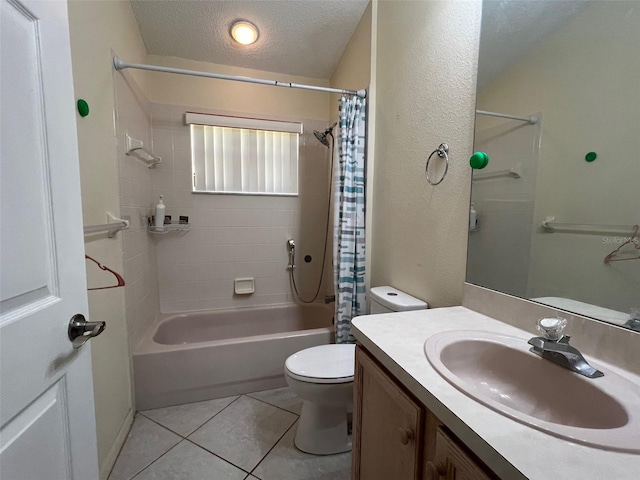 full bathroom with a textured ceiling, toilet, shower / bath combo with shower curtain, vanity, and tile patterned floors