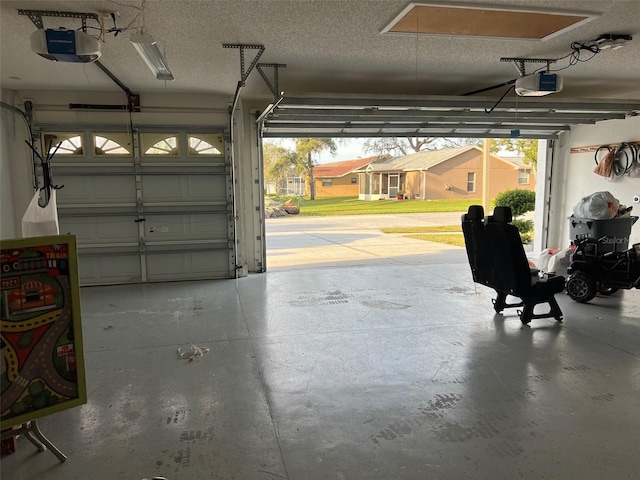 garage with a garage door opener and a carport