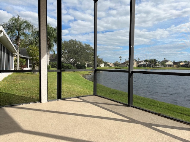 unfurnished sunroom featuring a water view