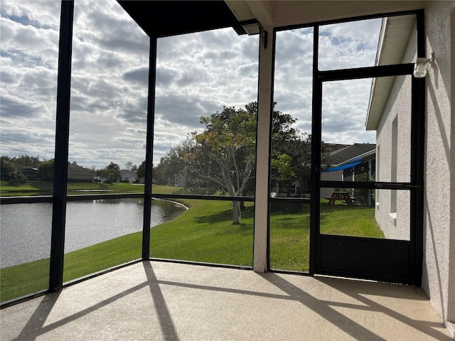 unfurnished sunroom with a water view