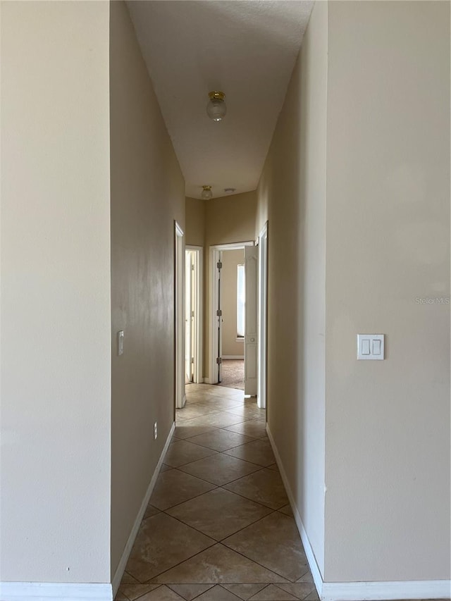 hallway featuring light tile patterned floors