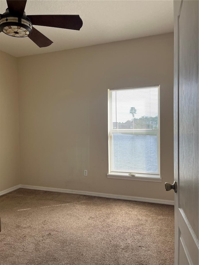 empty room with carpet floors and ceiling fan