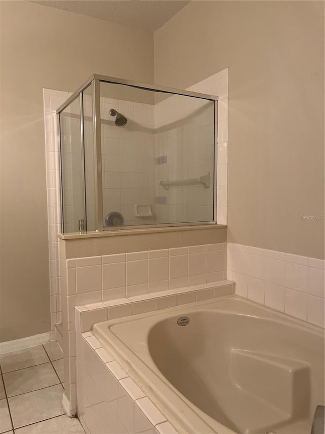 bathroom featuring tile patterned floors and shower with separate bathtub