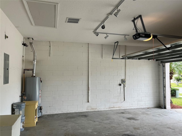 garage featuring electric panel, a garage door opener, and gas water heater