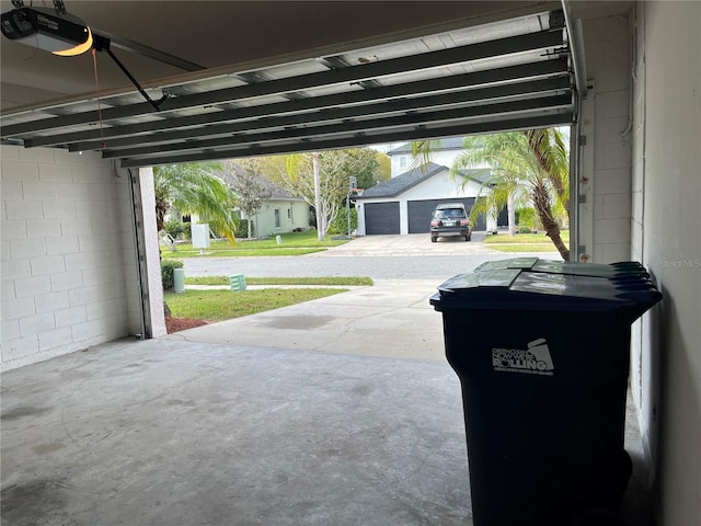 garage with a garage door opener and a carport