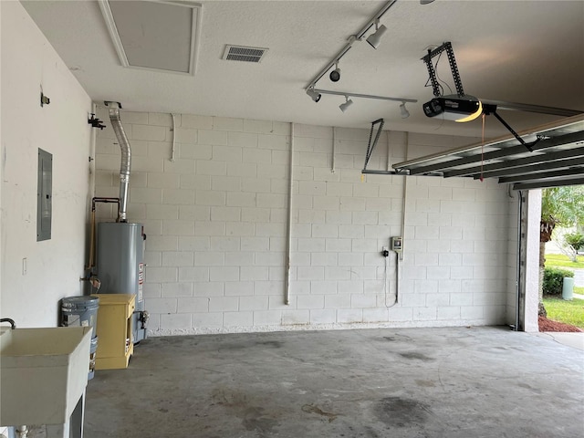 garage featuring electric panel, gas water heater, sink, and a garage door opener