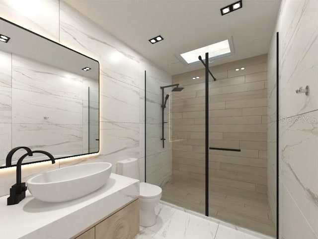 bathroom featuring vanity, a skylight, toilet, tile walls, and a tile shower