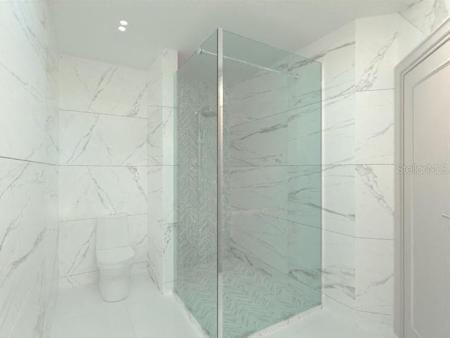 bathroom featuring a tile shower and toilet