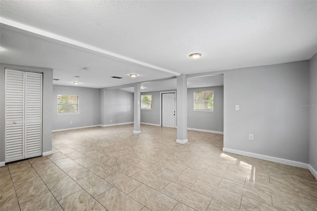 basement with a textured ceiling and plenty of natural light