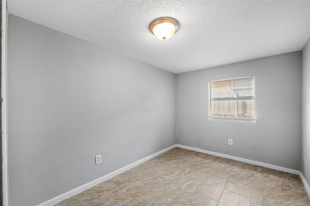 spare room with a textured ceiling