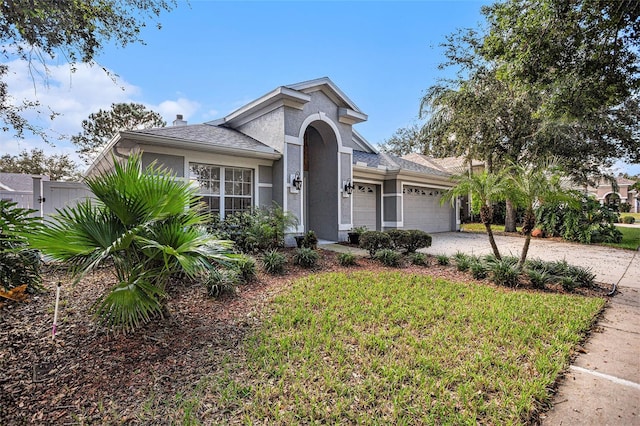 view of front of property with a garage and a front yard