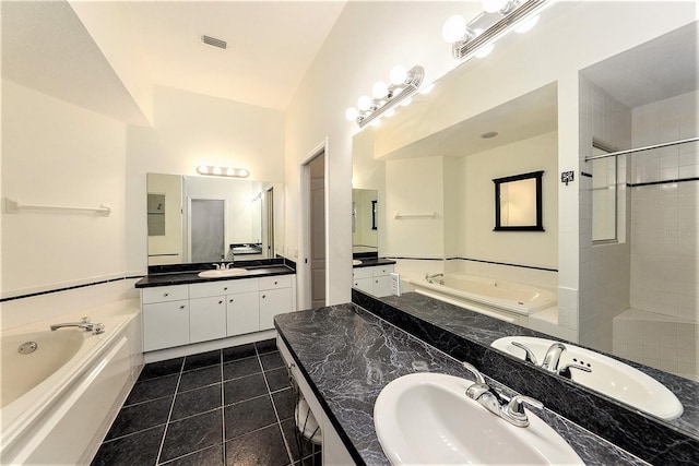 bathroom with tile patterned floors, plus walk in shower, vanity, and lofted ceiling