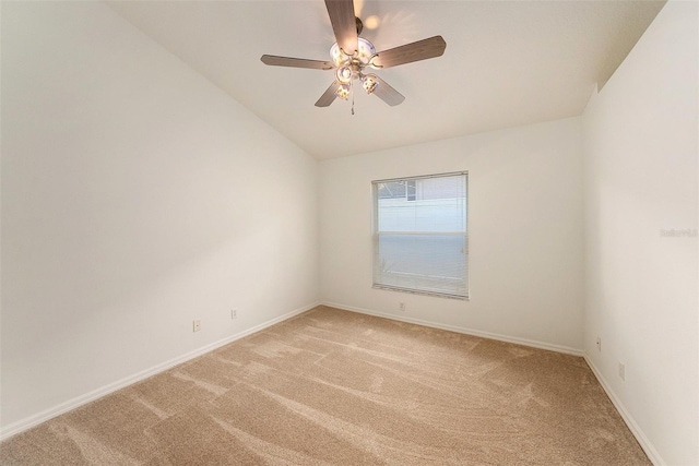 carpeted spare room featuring ceiling fan and lofted ceiling