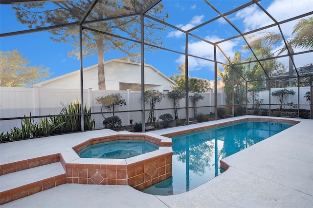 view of swimming pool with an in ground hot tub and a lanai