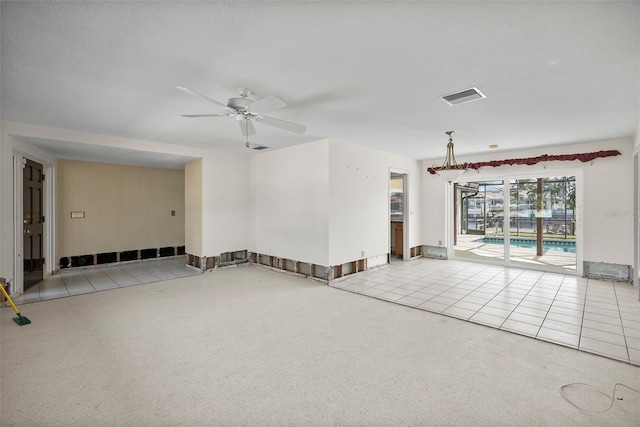 tiled empty room featuring ceiling fan