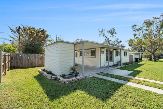 view of front of house featuring a patio and a front lawn