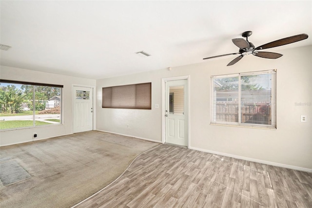 unfurnished living room featuring ceiling fan and light hardwood / wood-style flooring