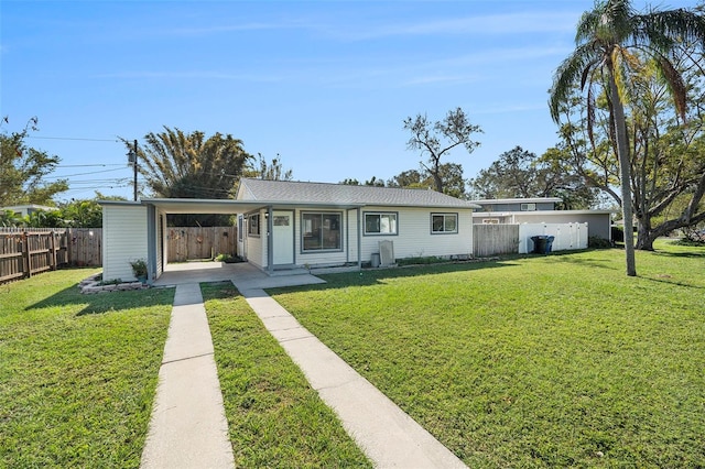 ranch-style home featuring a carport and a front lawn