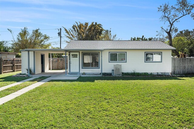 single story home featuring a carport and a front yard