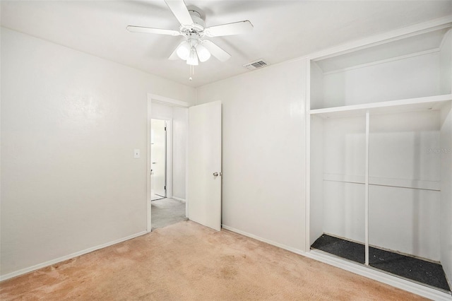 unfurnished bedroom with ceiling fan, a closet, and light carpet