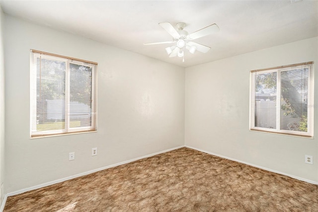 carpeted spare room with ceiling fan